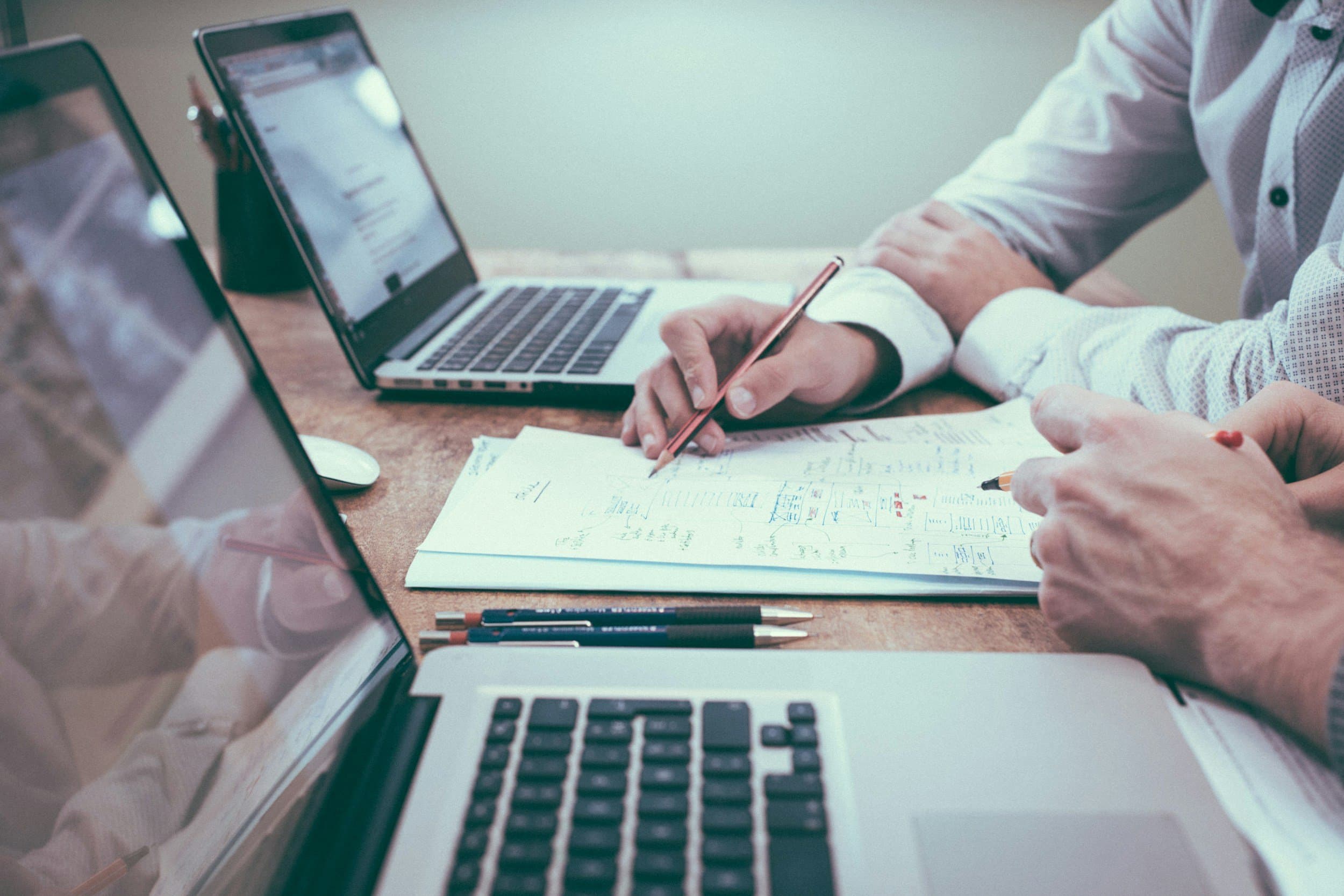 Two people working through a campaign plan at a desk